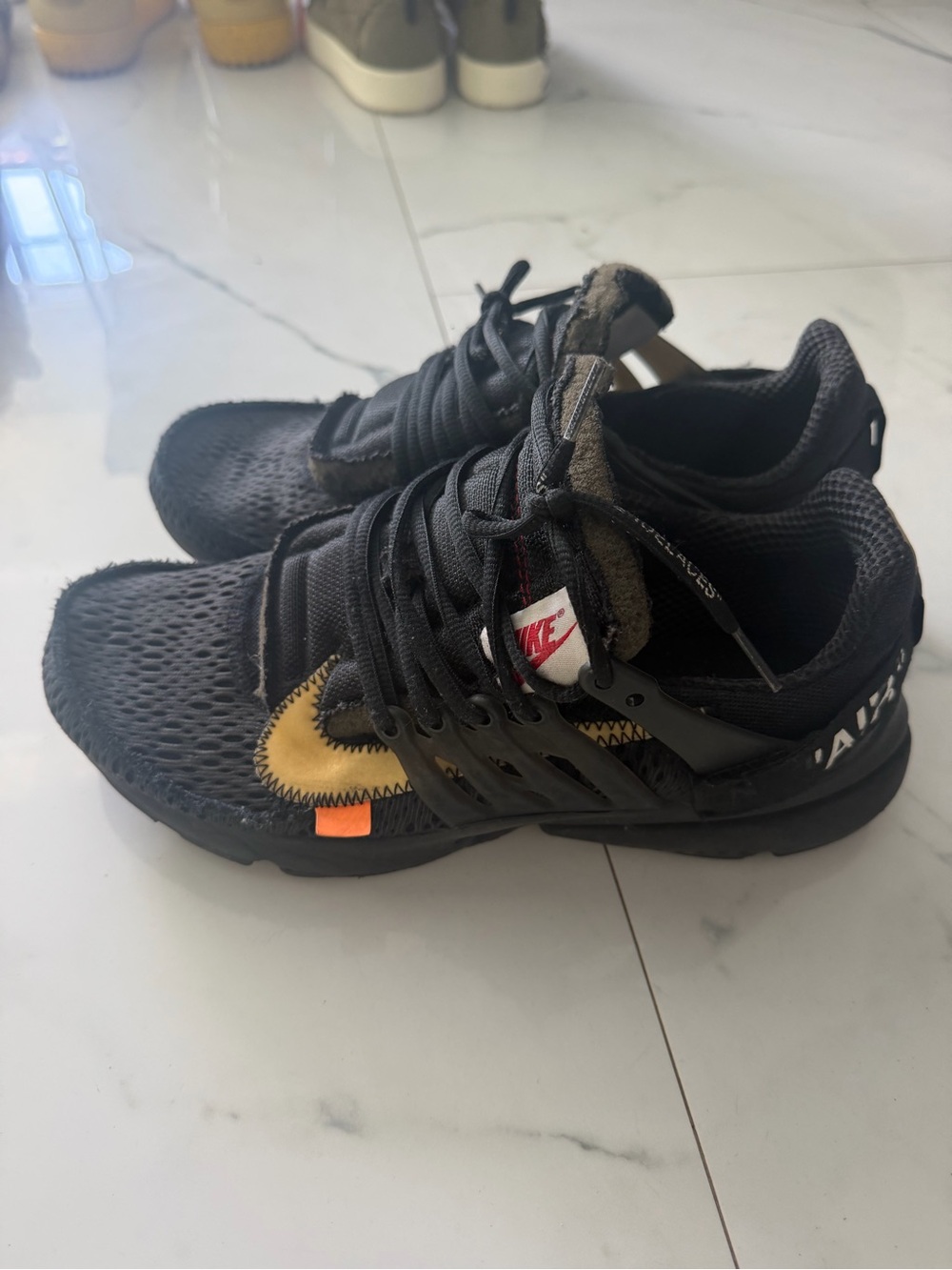 Nike Black Sneakers with Gold Swoosh and Orange Accent